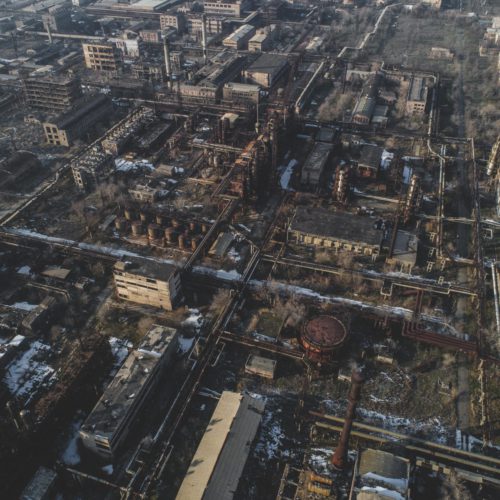 Large urban abandoned destroyed factory shot with a drone. Bird's view - Global Warming